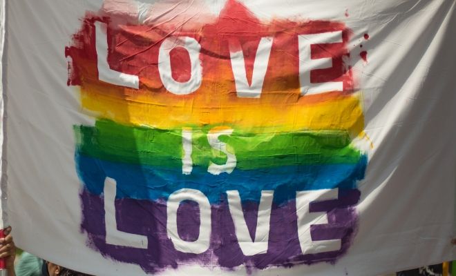white flag with love is love painted in celebration of Pride Month
